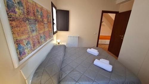 a room with a table with two white towels on it at Gaia Holidays Apartments in Cefalù