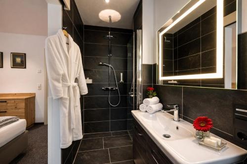 a bathroom with a sink and a shower at Lechappart in Hofen