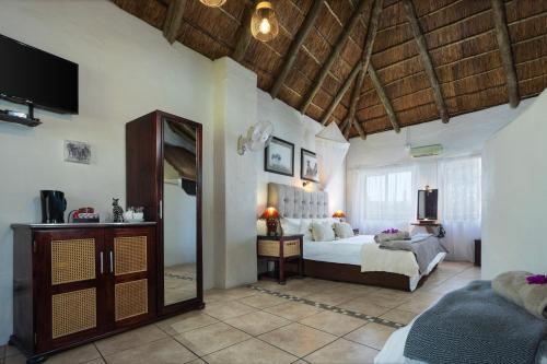 a bedroom with a bed and a mirror in a room at Elephants Footprint Lodge in Colchester