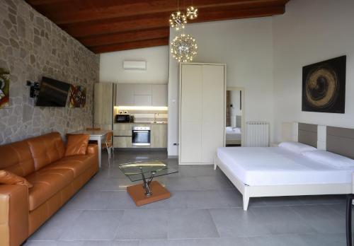 a living room with a bed and a couch at Ferrocino Resort in Galatone