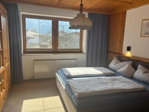 a bedroom with two beds and a window at Sonnenappartement in Mayrhofen