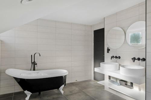 a bathroom with two sinks and a bath tub at Provident Suite - Free Wi-Fi - Sea View in Brixham