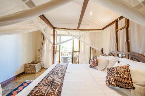 a bedroom with a large bed in a room at Beat's Hideaway in Galu