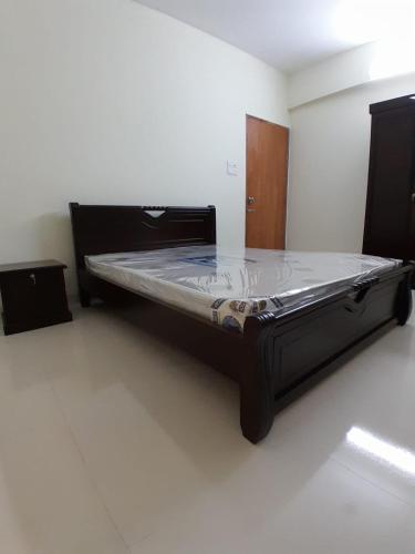 a bed in a room with a bed frame at Chiakunja in Dhaka
