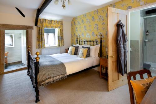 a bedroom with a bed and a walk in shower at Reddivallen Farmhouse in Boscastle
