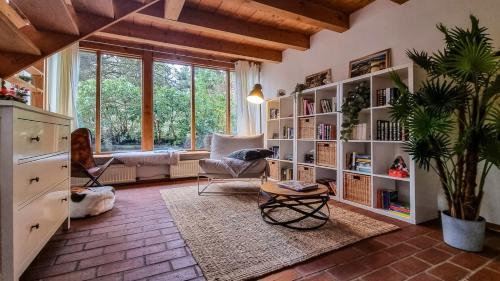 a living room with a large book shelf at Villa With Split-Level Architecture By Ammersee in Hechenwang