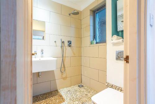 a bathroom with a shower and a toilet and a sink at Creewood - Elie in Elie