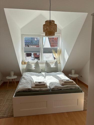 a bed in a room with a large window at Altstadtgold in Rostock