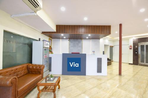 a lobby with a couch and a table in a room at Via Lazeeno in Faridabad