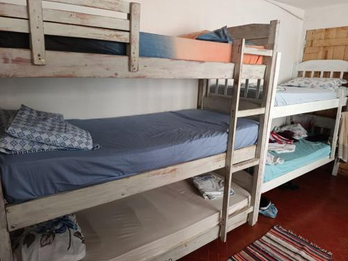 a couple of bunk beds in a room at La mansion caballero hostal in Asunción
