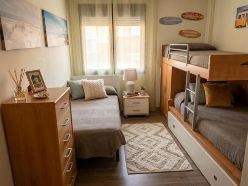 a small bedroom with a bunk bed and a desk at El Tornadillo in Gálvez