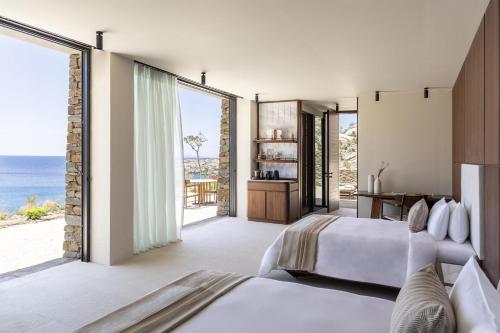 a bedroom with two beds and a view of the ocean at One&Only Kéa Island in Pisses