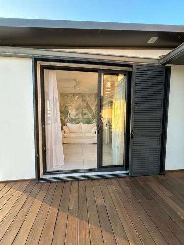 a room with a sliding glass door to a living room at le paradis vert bleu in Saint-Paul