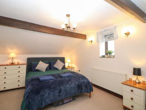 a bedroom with a bed and two night stands at Win Hill View Cottage in Hope