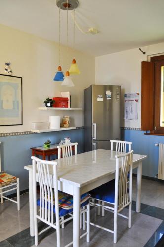 a kitchen with a table and chairs and a refrigerator at Il Glicine in Làconi