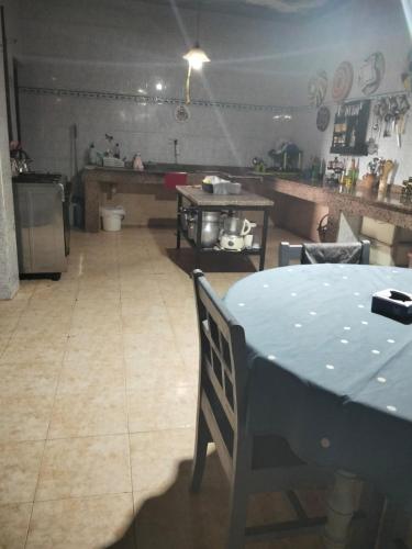 a kitchen with a blue table and a kitchen with a counter at Rhythm House in Essaouira