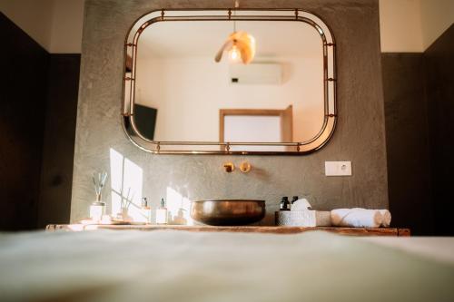 a bathroom with a sink and a mirror at Herdade dos Moreiros in Arronches