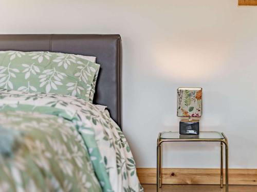 a bed with a side table with a lamp on it at 1 Bed in Launceston oc-86674 in North Petherwin