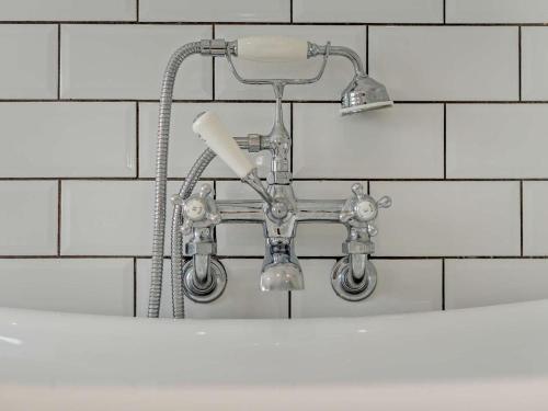 a shower head on a wall in a bathroom at 3 Bed in Newquay oc-53688 in Newquay