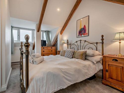 a bedroom with a large bed with white sheets and pillows at 3 Bed in Newquay oc-53688 in Newquay