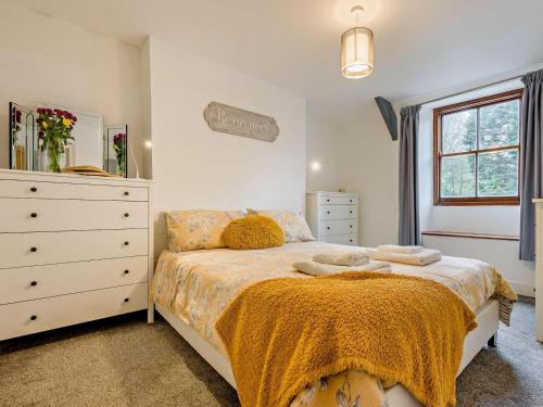 a bedroom with a large bed and a dresser at 2 Bed in Wadebridge oc-83130 in Little Petherick