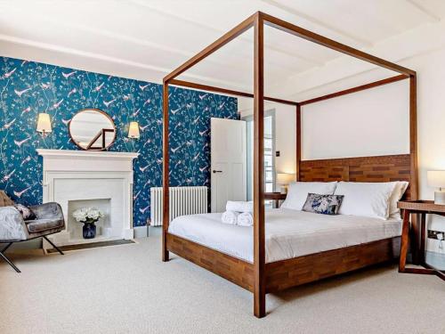 a bedroom with a canopy bed and a fireplace at 8 Bed in Newquay oc-81510 in Saint Columb Major
