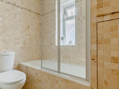 a bathroom with a shower and a toilet and a tub at 2 Bed in Looe oc-82537 in Looe