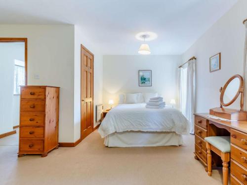 a white bedroom with a bed and a dresser at 2 Bed in St. Austell oc-82609 in St Austell