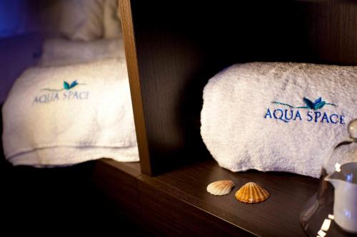 a picture of a towel with a spa logo on it at Mira Spiaggia in San Vito lo Capo