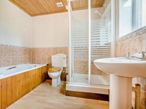 a bathroom with a toilet and a sink and a shower at 3 Bed in Padstow oc-treba in Saint Merryn