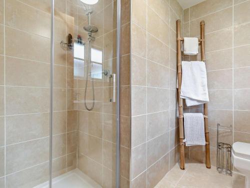 a shower with a glass door in a bathroom at 3 Bed in St. Columb oc-43079 in Saint Columb Major