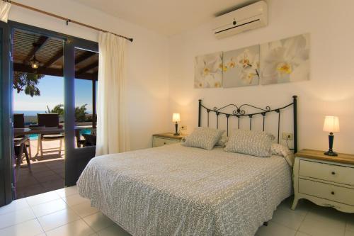 a bedroom with a bed and a view of the ocean at Villa Corona in Puerto del Carmen