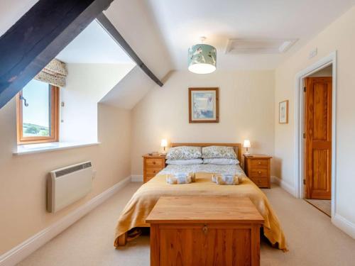 a bedroom with a large bed and a large window at 3 Bed in Bridport oc-dc049 in Chideock