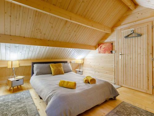 a bedroom with a large bed with yellow pillows on it at 2 Bed in Holsworthy oc-87766 in Week Saint Mary