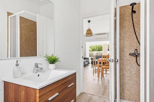 a bathroom with a sink and a mirror at Villa Rincon by Villa Plus in Cala Blanca