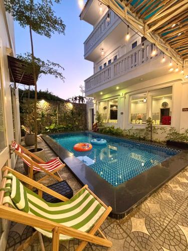 a swimming pool in the backyard of a house at Fullhouse Hoian in Hoi An