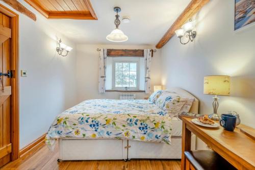 a bedroom with a bed and a desk and a window at 1 Bed in Winskill oc-c36298 in Little Salkeld