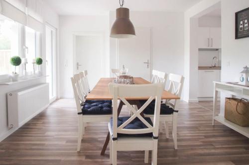 a dining room with a wooden table and chairs at Bootshaus in Timmendorfer Strand