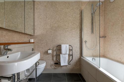 a bathroom with a sink and a toilet and a shower at Juniper Cottage - Elie in Elie