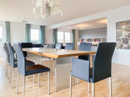 a dining room with a large wooden table and chairs at Loft in Timmendorfer Strand