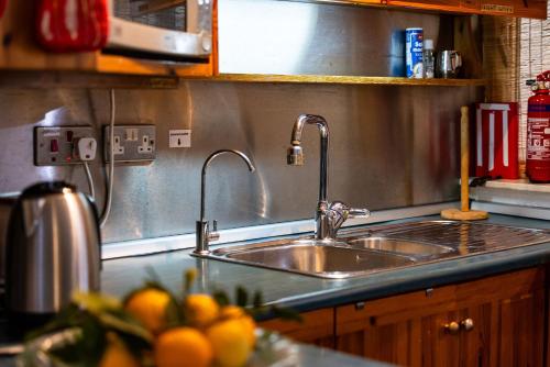 a kitchen sink with two faucets on a counter at GhadiraBay seafront with sea views by Homely in Mellieħa