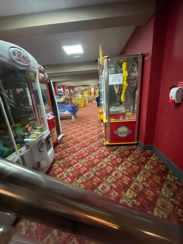 a room with a video game console and a arcade at Neal 6 berth static rental in Skegness