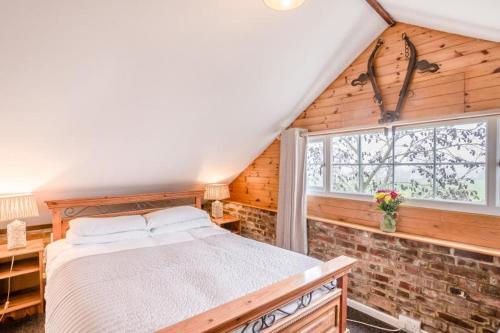 a bedroom with a bed and a window at Hunston Mill Self Catering Dog Stay For Free in Chichester