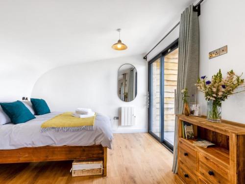 a bedroom with a bed and a mirror at 1 Bed in Bude oc-88498 in Morwenstow