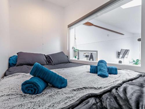 a bedroom with a bed with blue pillows on it at 1 Bed in Penzance oc-93410 in Sennen