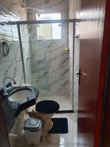 a bathroom with a toilet and a glass shower at Terramar condominium! Coral beach! in Tamoios
