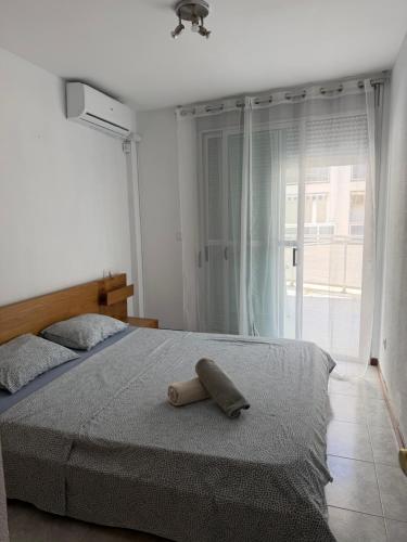 a bedroom with a bed with a towel on it at Mont-Roig Del Camp in Tarragona