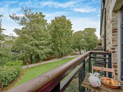 a balcony with a table and a bowl of bread at 3 Bed in Lostwithiel oc-93041 in Lostwithiel