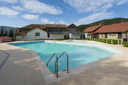 a large swimming pool in front of a house at Casa lo Sastre - Jasa in Jasa