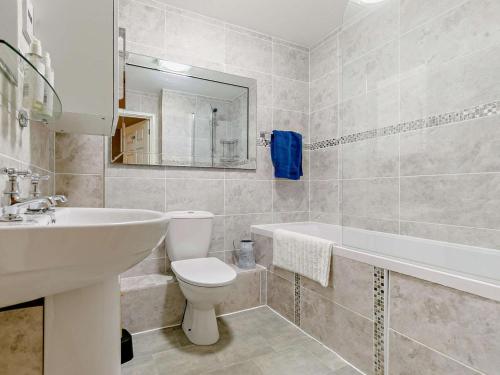 a bathroom with a sink and a toilet and a tub at 3 Bed in St. Austell oc-90218 in Charlestown
